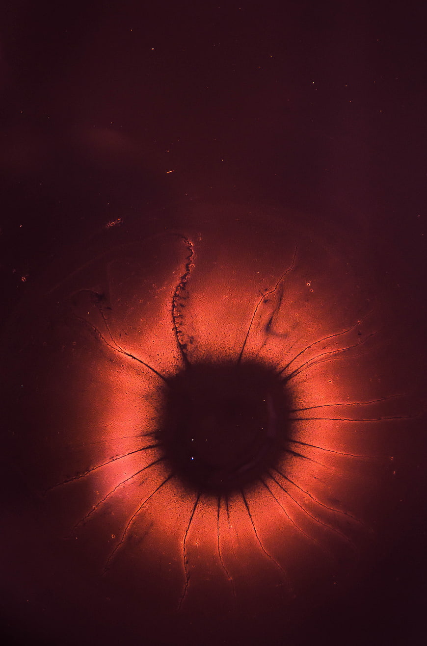 Abstract Macro Red Eye with Dark Pupil and Radiating Lines