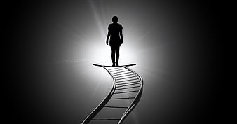 Silhouette of person standing on DNA helix ladder reaching for light