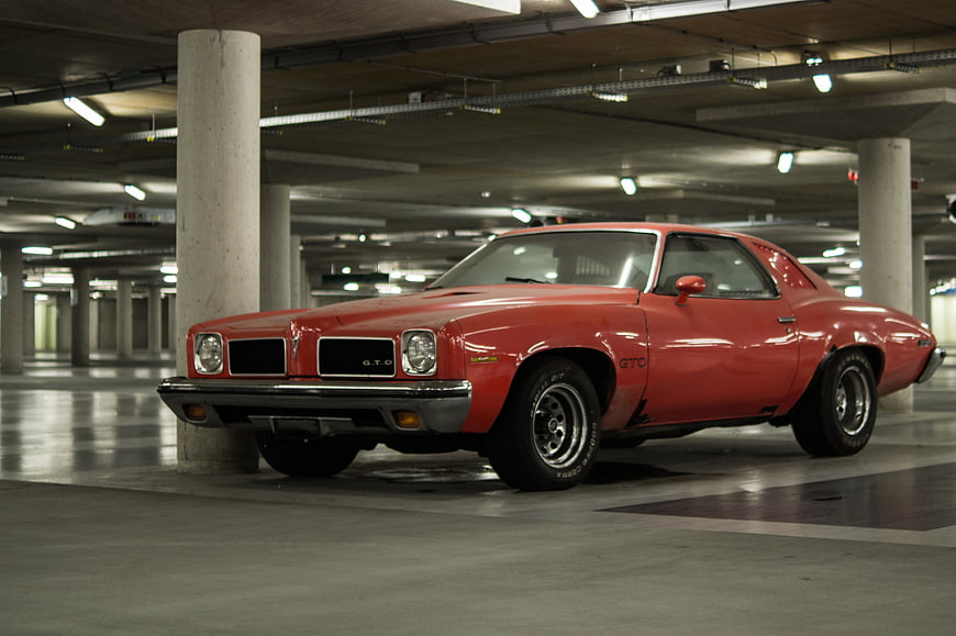 Classic Red Pontiac GTO Muscle Car in Parking Garage