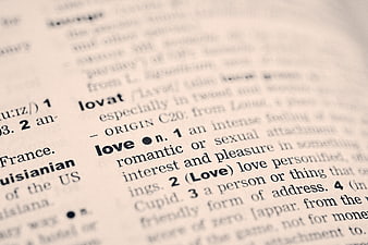 Close-up of dictionary definition of the word love