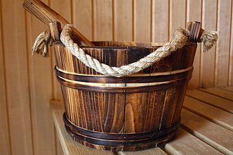 Traditional wooden sauna bucket with rope handle