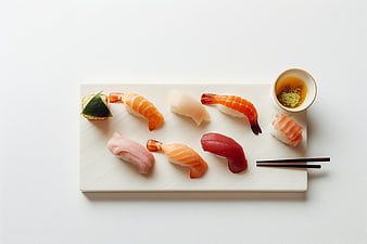 Assorted nigiri sushi platter with soy sauce and chopsticks