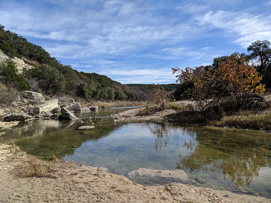 Serene River Landscape with Clear Water and Autumn Trees
