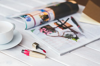 Red Lip Gloss and Coffee on White Desk with Magazine