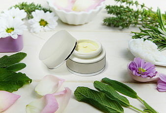 Natural Herbal Skincare Cream Jar With Fresh Flowers And Green Leaves