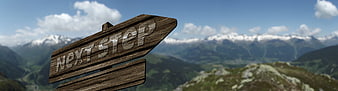 Wooden Next Step Signpost Against Mountain Landscape