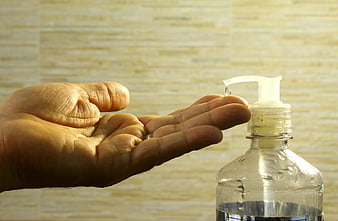 Hand Receiving Drop From Alcohol Gel Dispenser Bottle