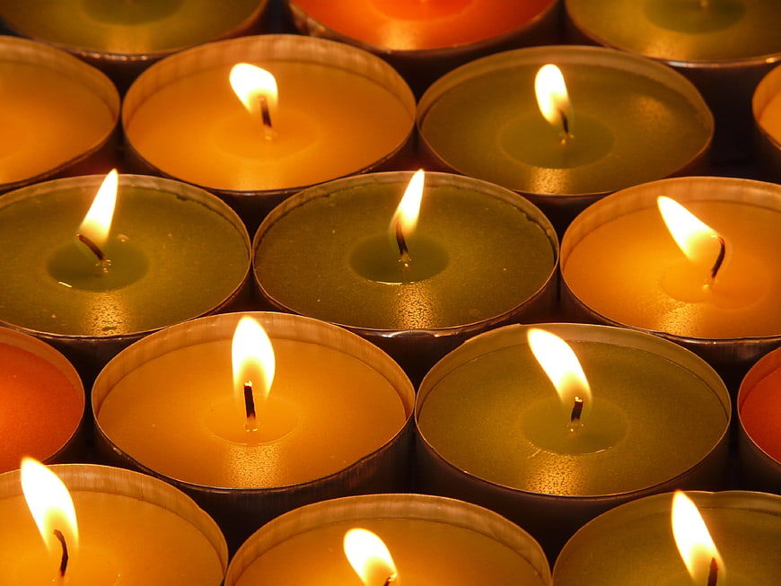 Close-up of burning tea light candles in a grid pattern