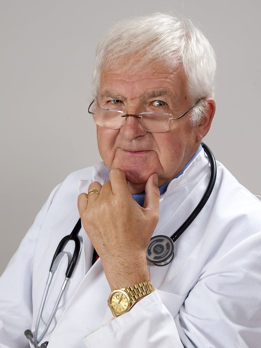 Senior male doctor with stethoscope in white coat