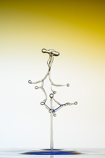 Abstract water splash droplet against yellow gradient background