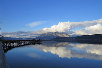 Serene Lake Reflection with Mountain and Wooden Pier