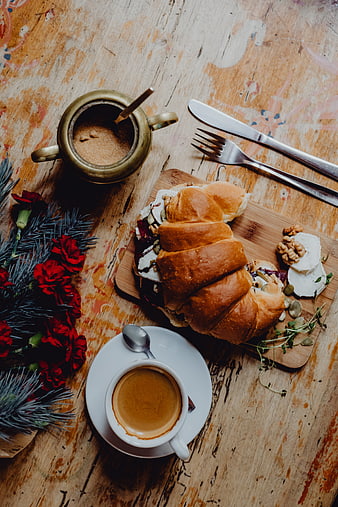 Top view of croissant sandwich with coffee on rustic wooden table