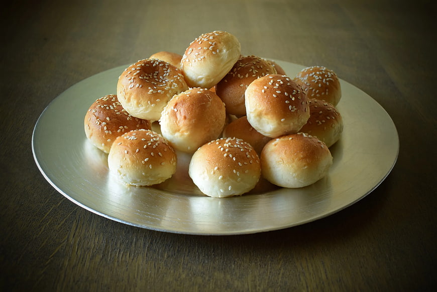 Golden Sesame Buns on Silver Plate