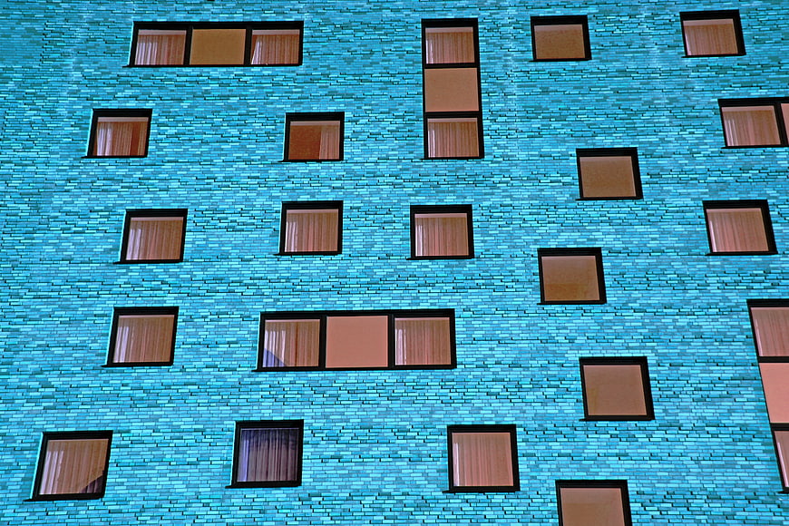 Modern Blue Brick Facade with Scattered Windows