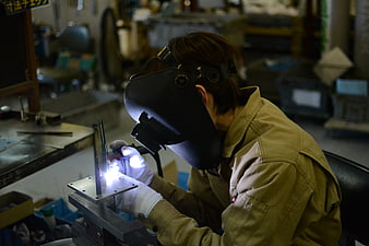 Craftsman Welding Metal in Industrial Workshop
