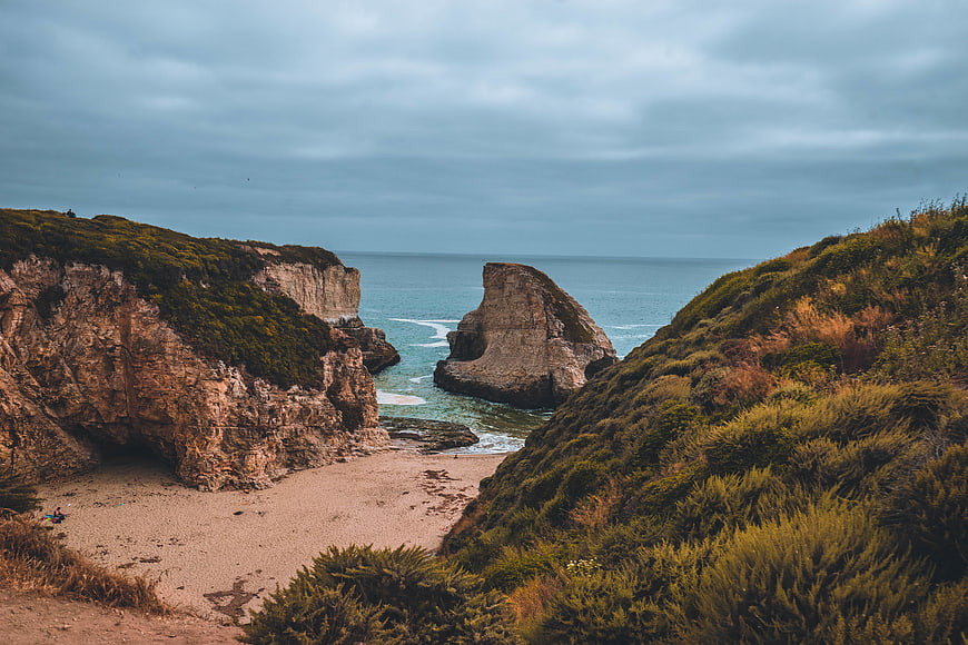 Dramatic coastal landscape with sea stack and sandy cove
