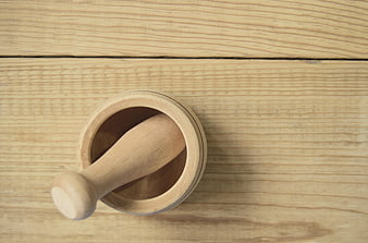 Wooden mortar and pestle on rustic table background