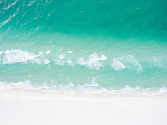 Aerial View of Turquoise Ocean Waves Crashing on White Sandy Beach