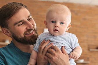 Happy Father Holding Adorable Baby Boy Portrait