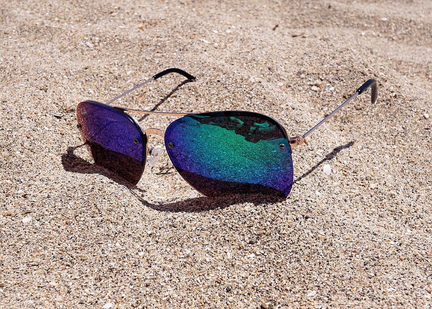Reflective Sunglasses on Sandy Beach