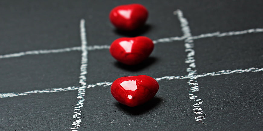 Red Heart Stones Winning Tic Tac Toe Game on Chalkboard