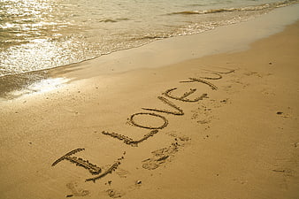 I Love You Written in Sand on Beach Shore