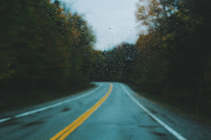 Rainy Road Through Autumn Forest View From Car