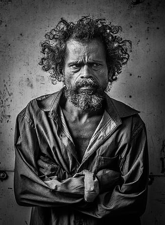 Intense black and white portrait of a rugged man with curly hair