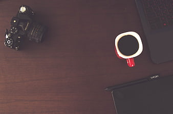 Flat Lay of DSLR Camera, Coffee, and Laptop on Wooden Desk