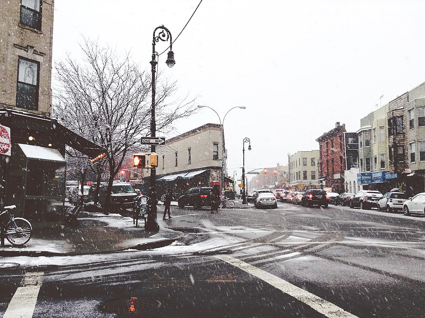 Snowy Brooklyn Street Scene with Traffic and Buildings