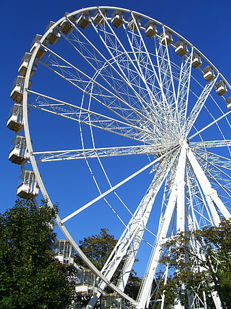 White Ferris Wheel Against Blue Sky