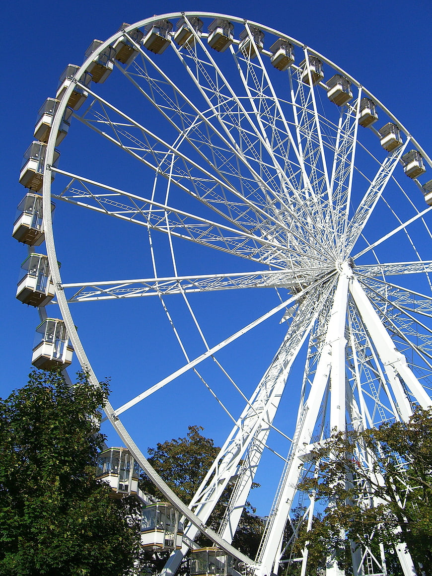 White Ferris Wheel Against Blue Sky