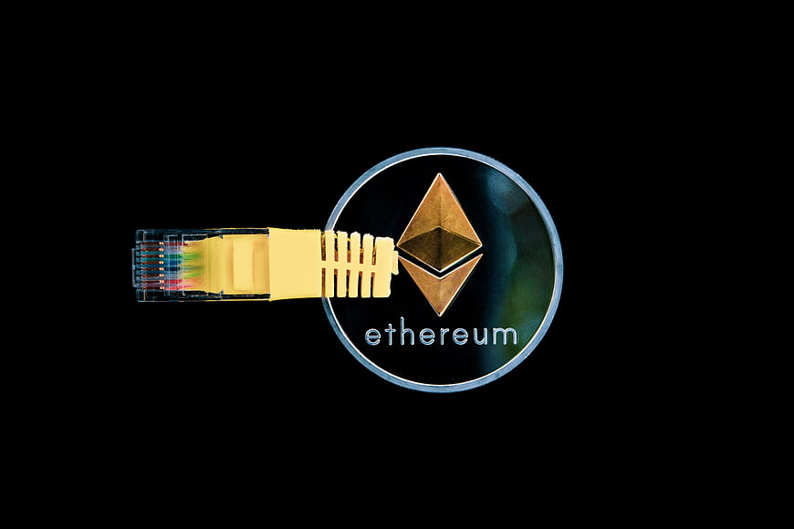 Ethereum coin with ethernet cable connector on black background