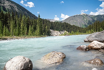 Turquoise glacial river flowing through Canadian Rocky Mountains