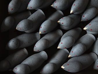 Gray ceramic bird figurines with red eyes and gold beaks