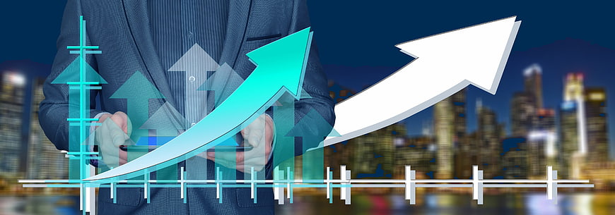 Businessman with digital growth chart and city skyline background