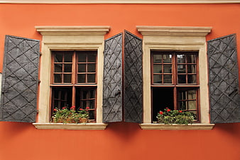 Vintage Orange Facade With Wooden Shutters And Flower Boxes