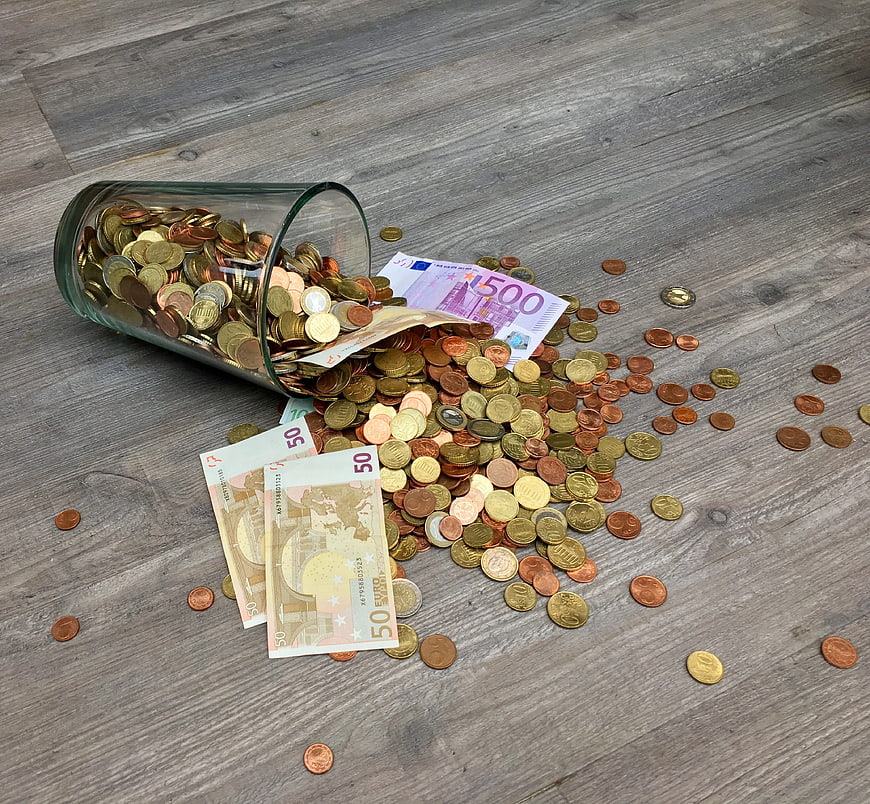 Spilled Euro Coins and Banknotes on Gray Wood