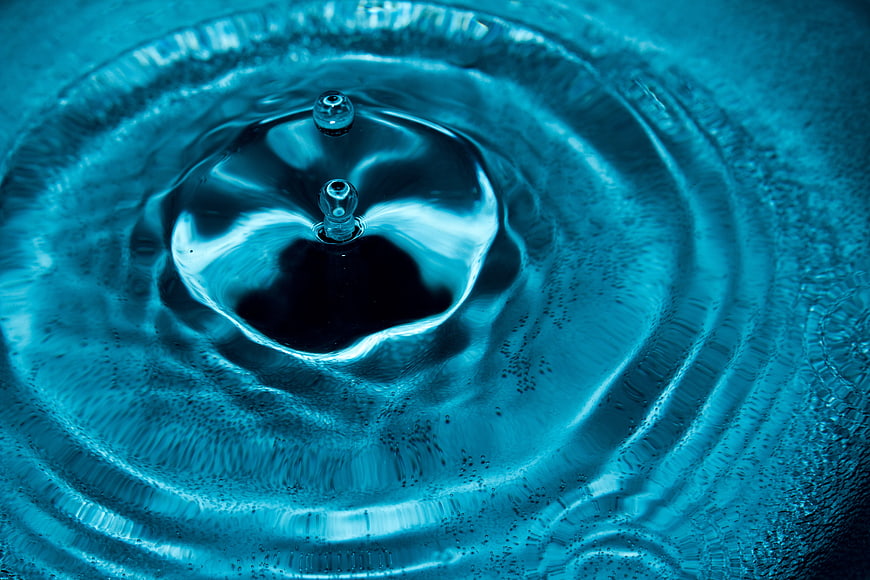 Abstract Blue Water Drop Splash with Ripples