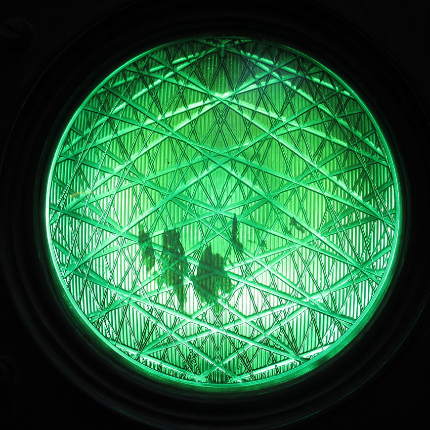 Close-up of Green Traffic Light Lens with Reflections