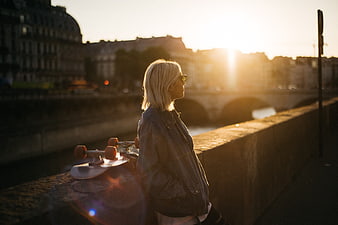 Woman with Skateboard on Paris Bridge at Sunset