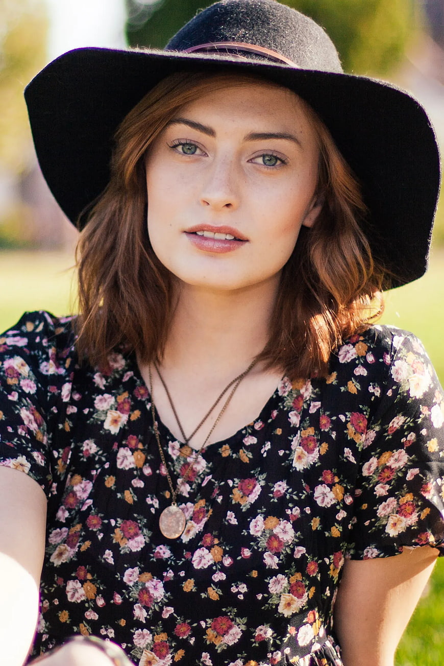 Portrait of Woman in Black Hat and Floral Dress