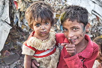 Portrait of two young children in a slum environment