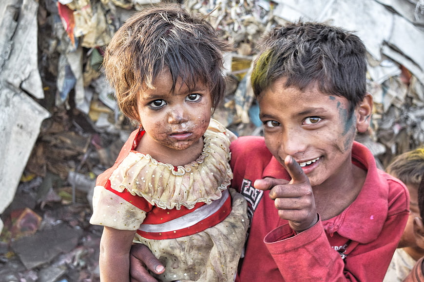 Portrait of two young children in a slum environment