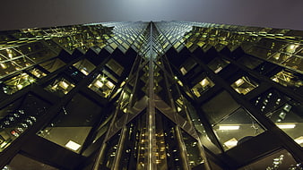 Low angle view of modern glass skyscraper at night