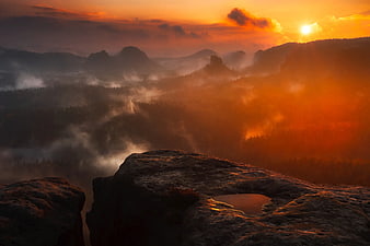 Dramatic Sunset Over Misty Mountain Forest Landscape