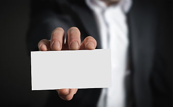 Businessman in suit holding blank white business card mockup