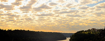 Panoramic River Valley at Golden Hour with Cloudy Sky
