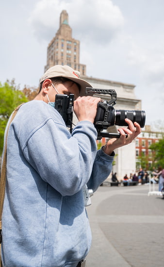 Filmmaker operating professional cinema camera outdoors