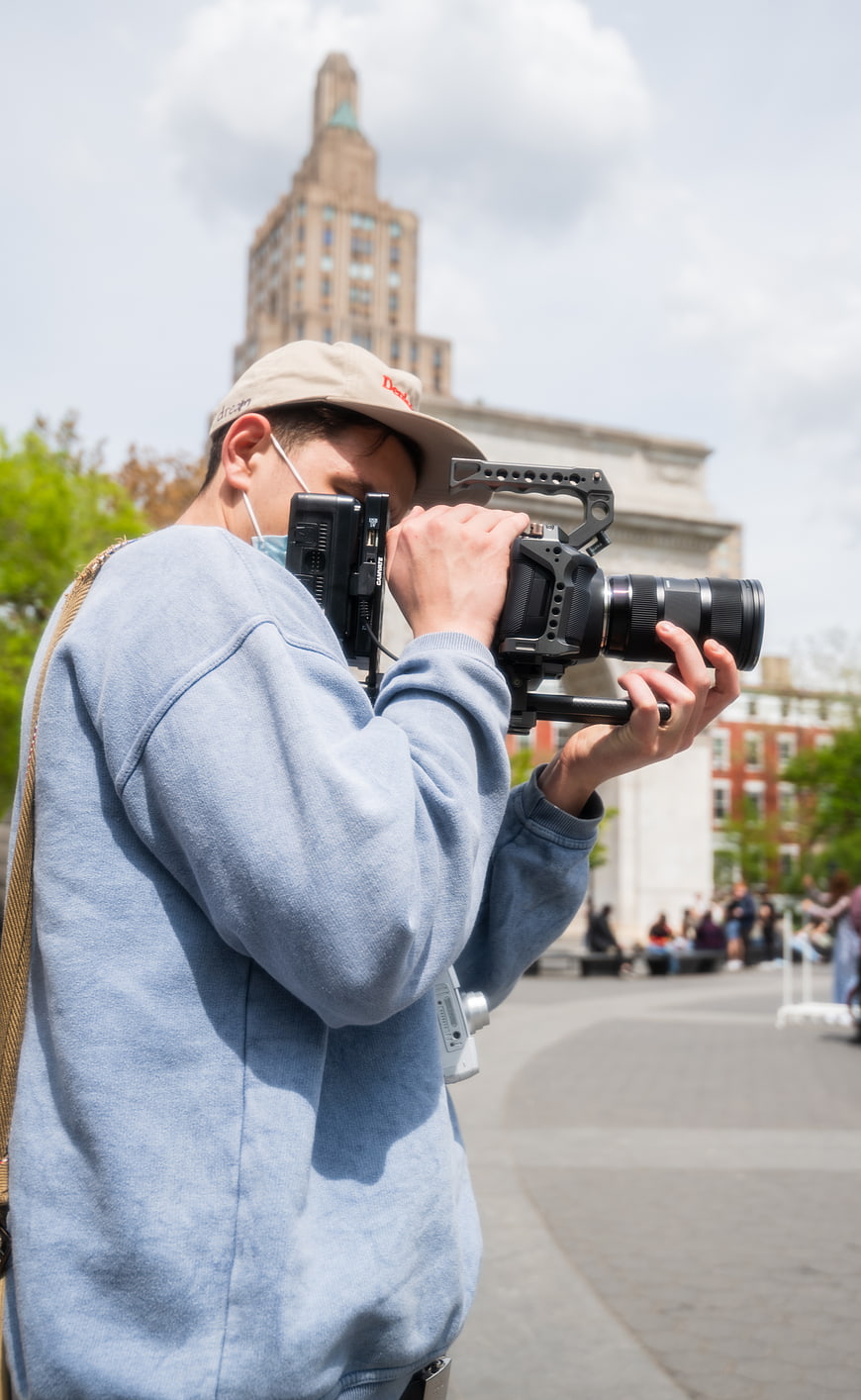Filmmaker operating professional cinema camera outdoors